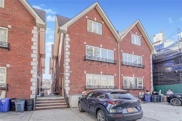 a front view of a building with parking space