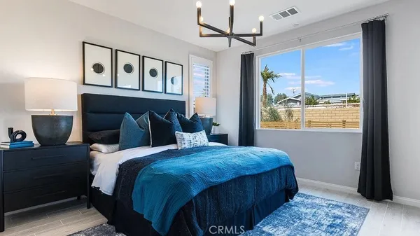 a bedroom with a large bed and a window