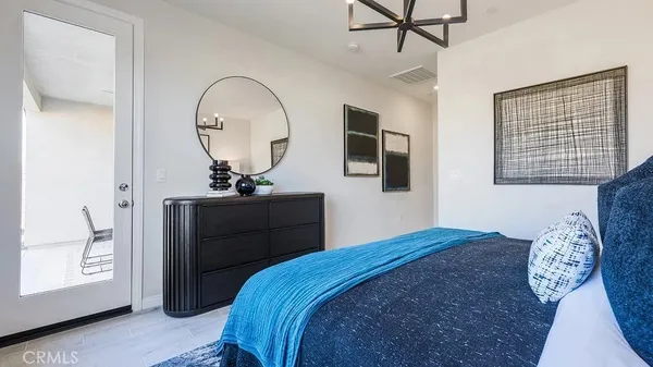 a bedroom with a bed and a mirror