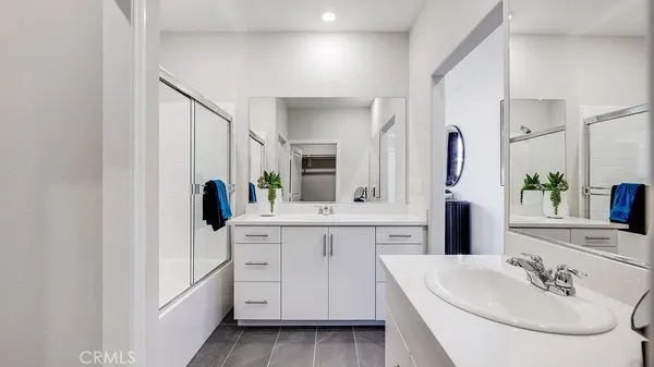 a spacious bathroom with a double vanity sink and mirror