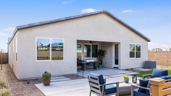 a view of a house with backyard and sitting area