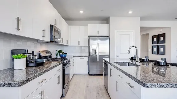 a kitchen with sink a stove and refrigerator