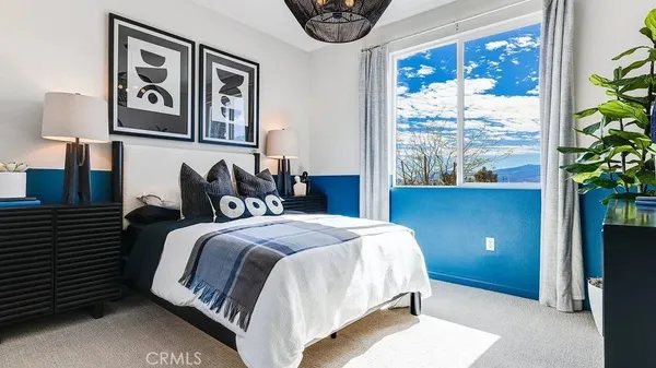 a bedroom with a bed and a painting on the wall