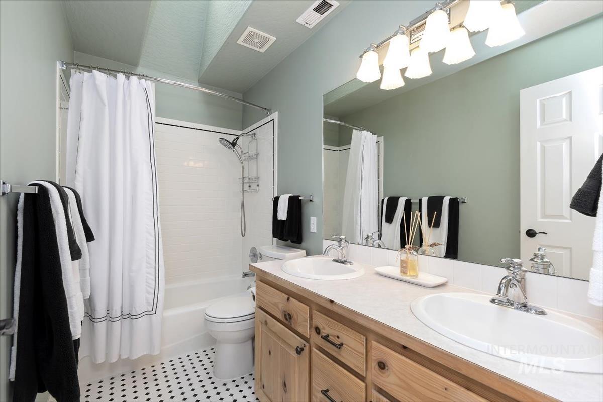 14111 Towers Drive Caldwell, ID 83607 - Photo 20 of 50 Full bathroom with shower / tub combo, double vanity, and light tile patterned floors
