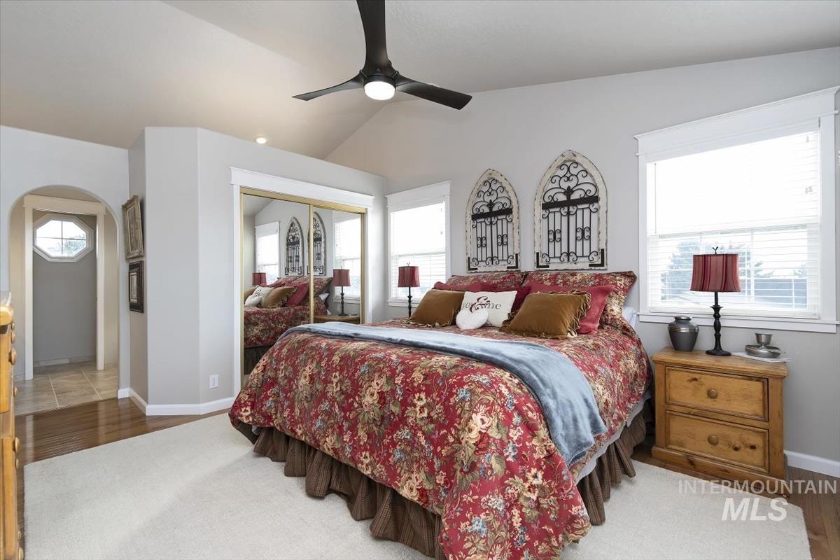 14111 Towers Drive Caldwell, ID 83607 - Photo 22 of 50 Bedroom with lofted ceiling, a closet, a ceiling fan, arched walkways, and dark wood-type flooring
