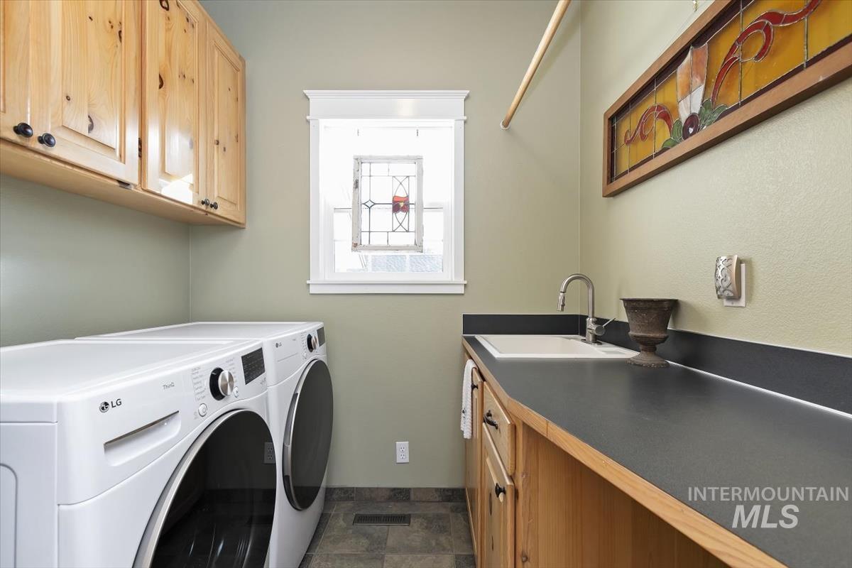 14111 Towers Drive Caldwell, ID 83607 - Photo 27 of 50 Laundry room with washer and clothes dryer, cabinet space, and stone finish flooring