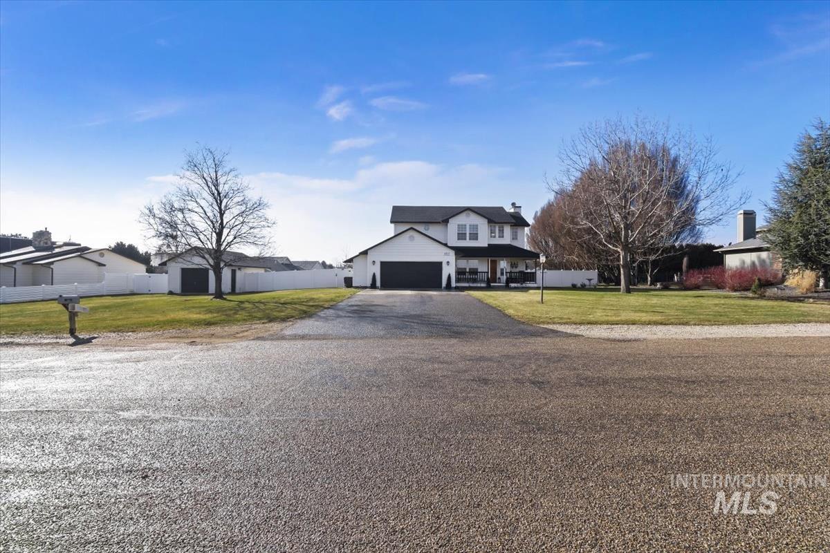 14111 Towers Drive Caldwell, ID 83607 - Photo 39 of 50 View of front facade featuring driveway, covered porch, a residential view, and an attached garage