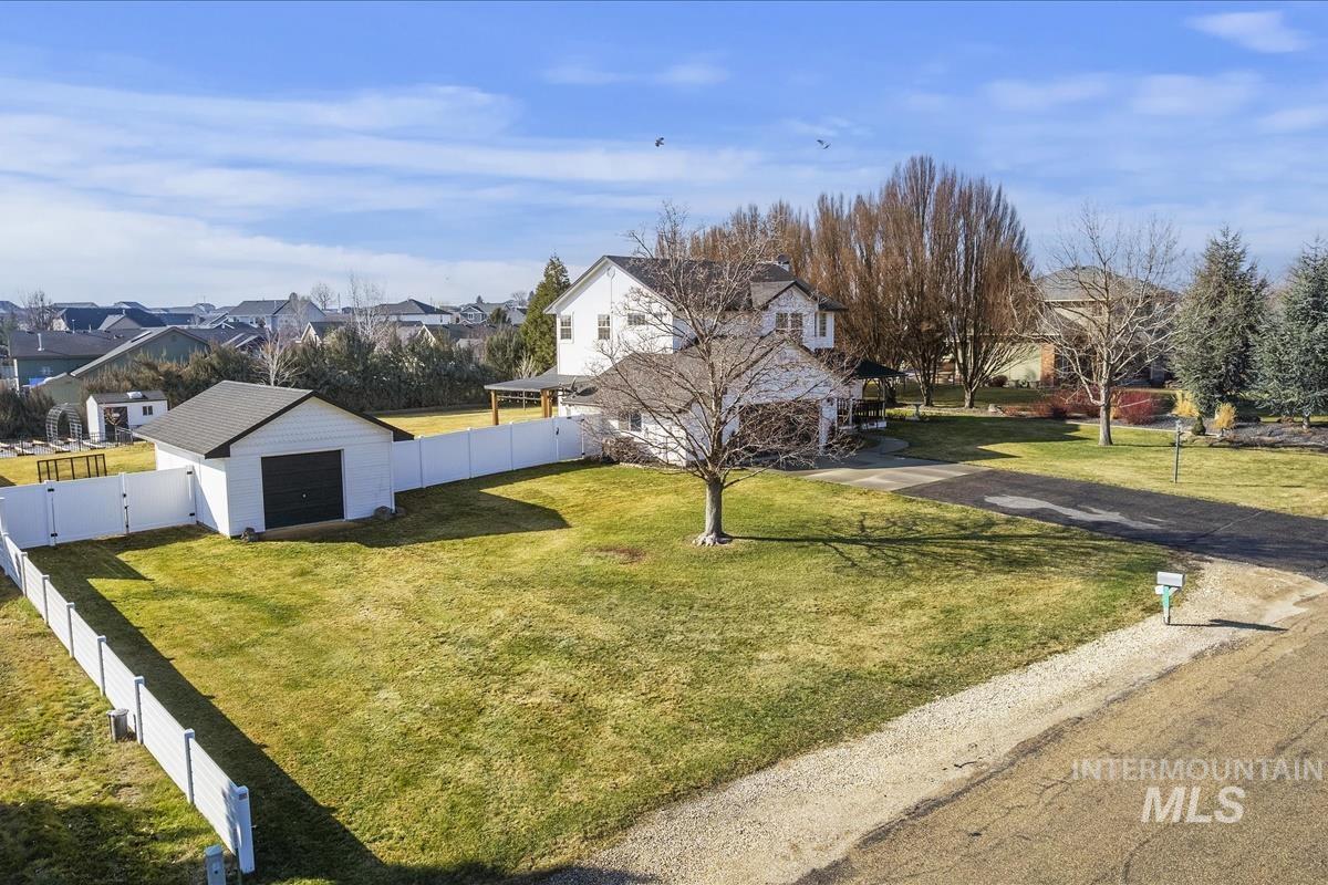 14111 Towers Drive Caldwell, ID 83607 - Photo 42 of 50 View of front of home with a residential view, a fenced backyard, an outbuilding, and a gate