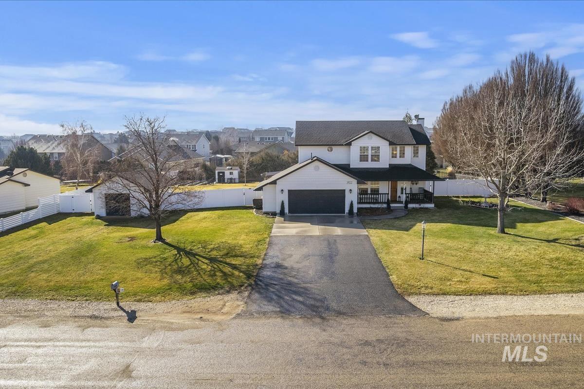 14111 Towers Drive Caldwell, ID 83607 - Photo 43 of 50 View of front of house featuring covered porch, driveway, a residential view, and an attached garage