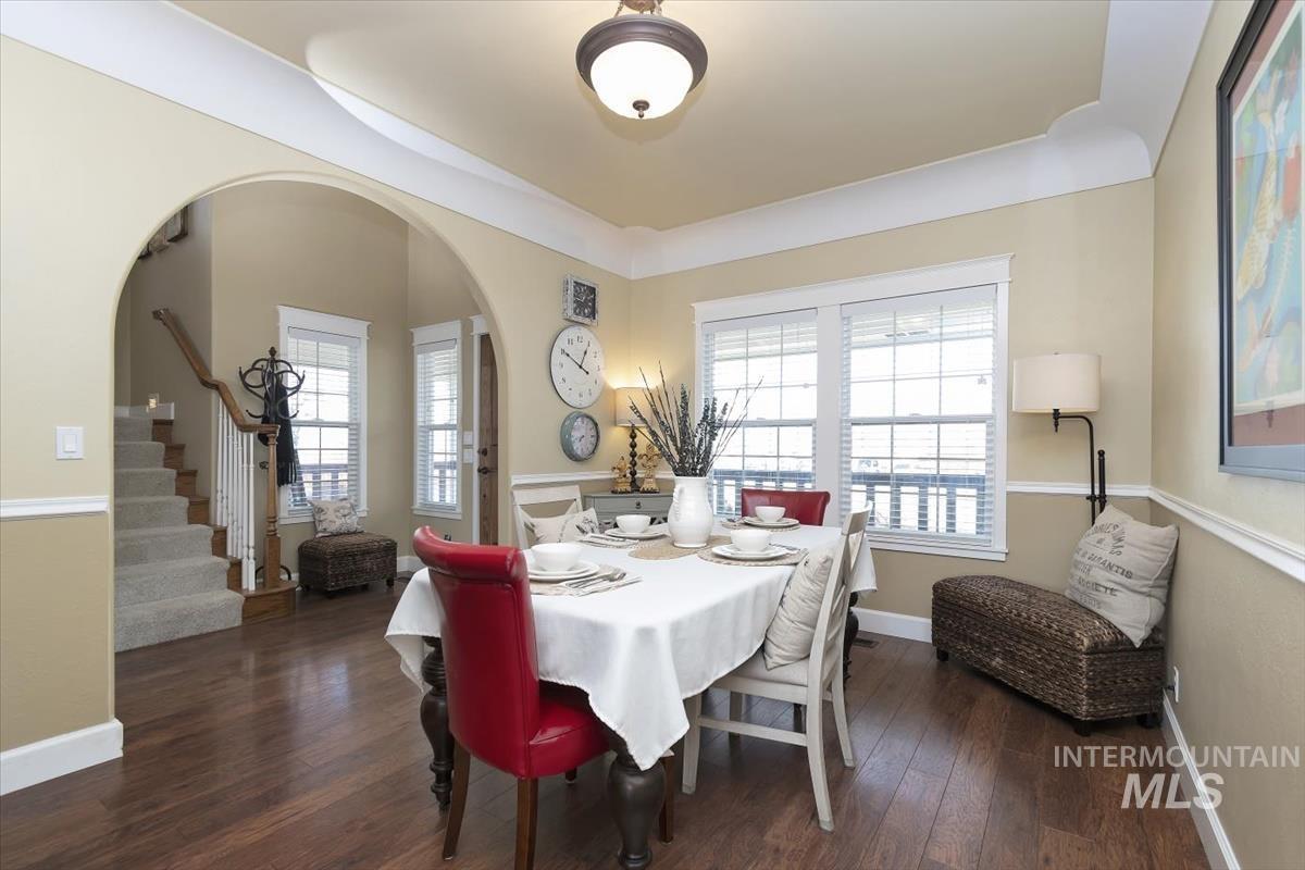 14111 Towers Drive Caldwell, ID 83607 - Photo 5 of 50 Dining space with stairs, dark wood-type flooring, and arched walkways