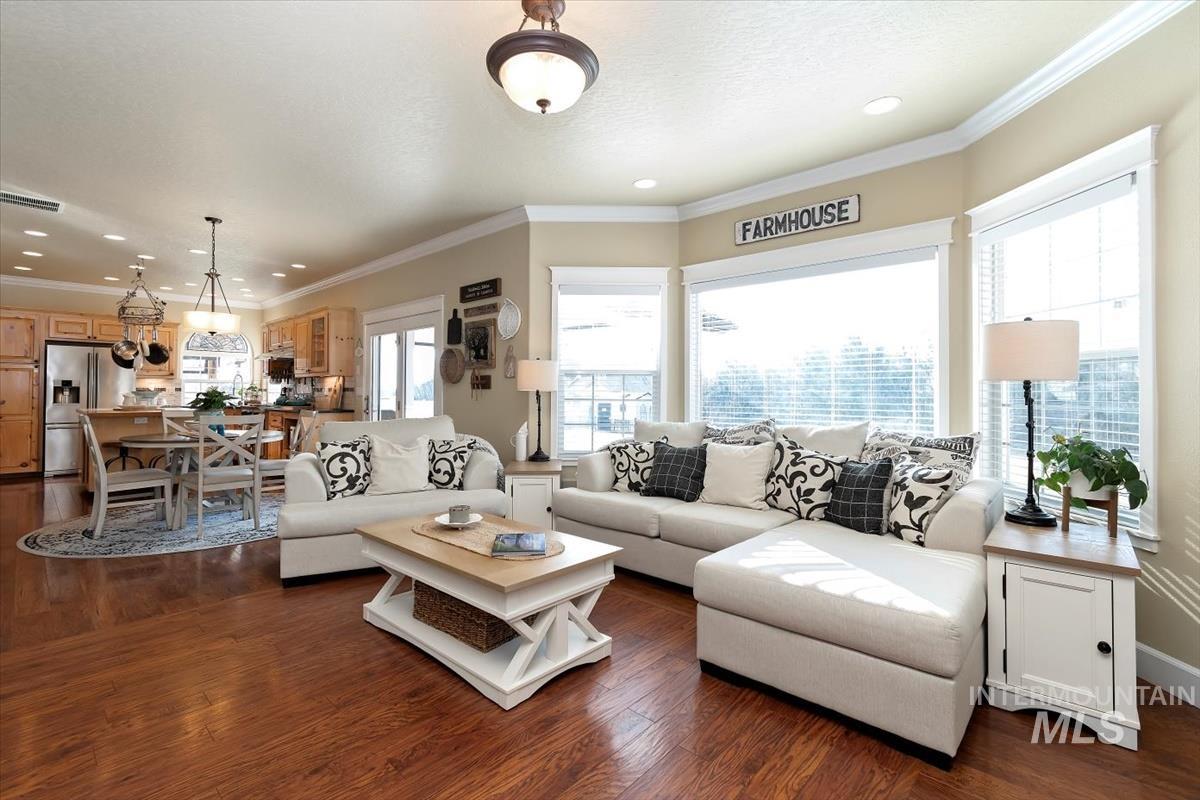 14111 Towers Drive Caldwell, ID 83607 - Photo 7 of 50 Living area featuring crown molding, dark wood-style floors, and recessed lighting