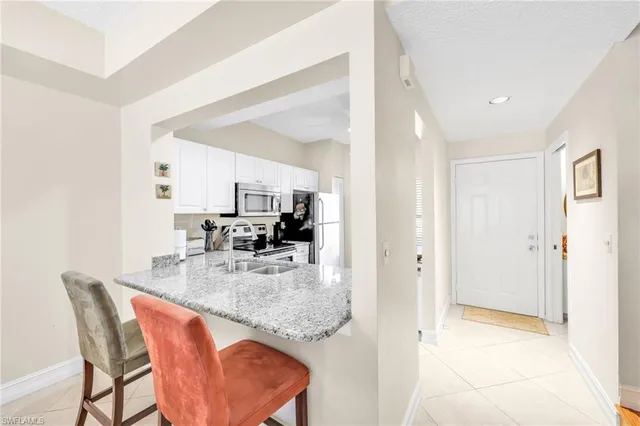 a dining room with furniture a chandelier and wooden floor