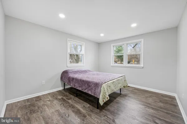 a spacious bedroom with a bed and a window