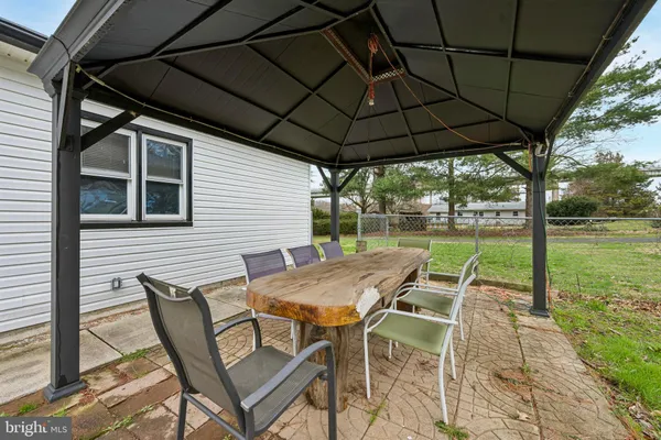 a patio with a yard table and chairs
