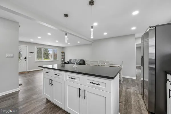 a kitchen with stainless steel appliances granite countertop a refrigerator and a sink