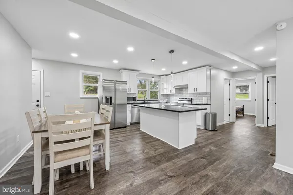 a large kitchen with a table and chairs
