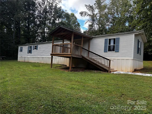 a view of backyard with deck and a garden