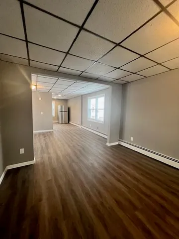 a view of a room with wooden floor