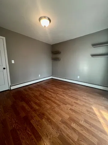 a view of room with wooden floor