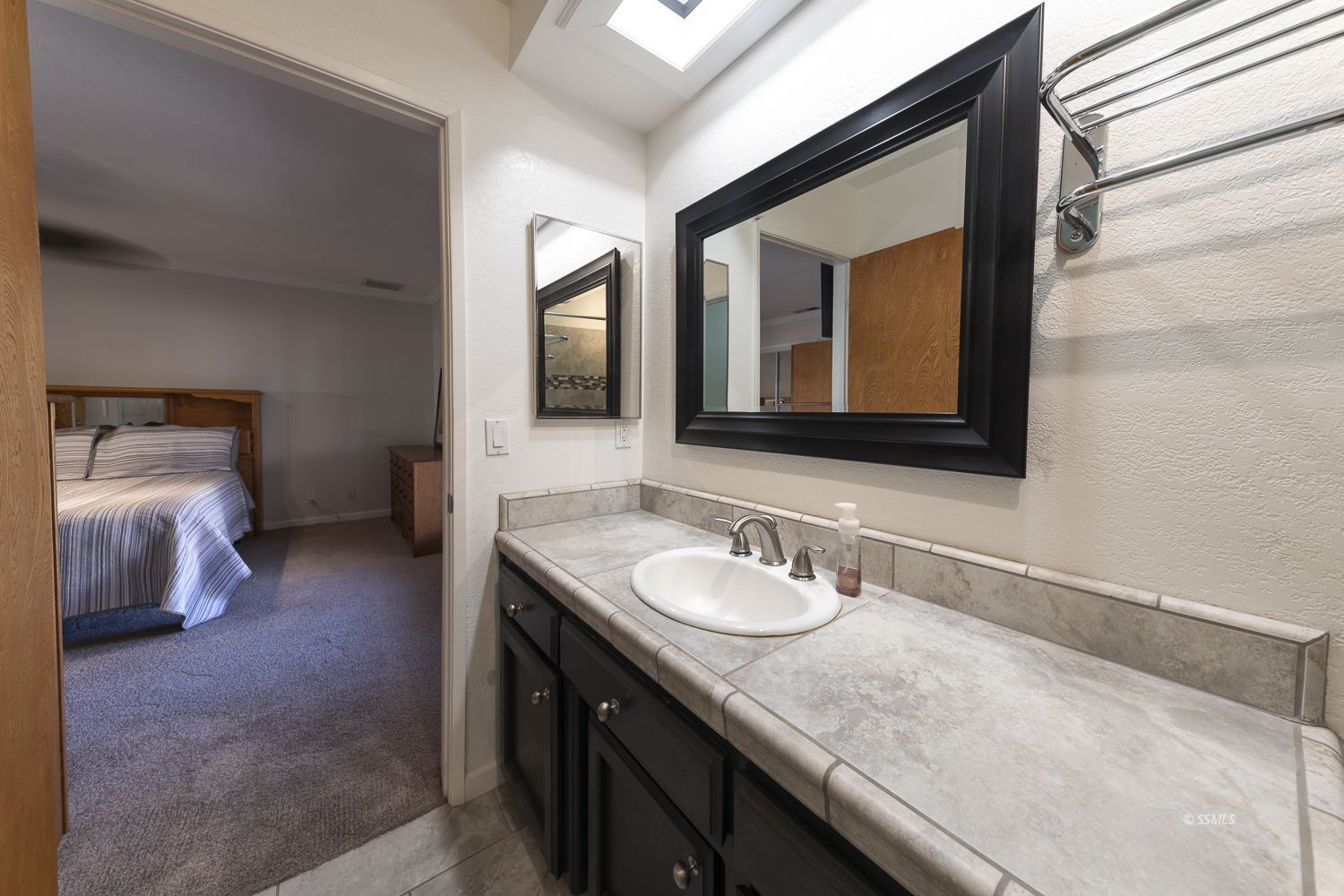 418 Mt Rainier Place Ridgecrest, CA 93555 - Photo 26 of 45 a en suite bathroom with a granite countertop sink and a mirror