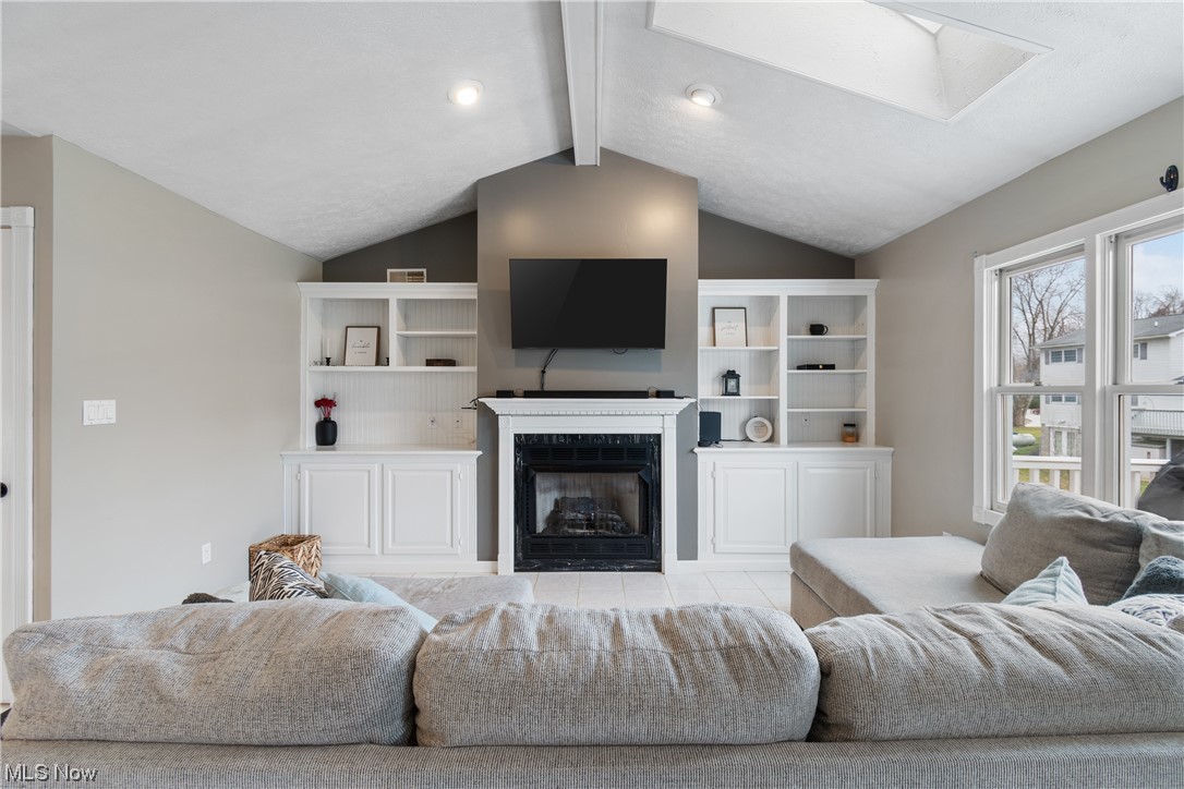 53330 High Ridge Road Bridgeport, OH 43912 - Photo 5 of 34 Living room with light tile floors and lofted ceiling with skylight