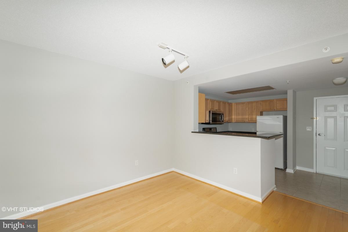 2726 Gallows Road, Unit 1202 Vienna, VA 22180 - Photo 11 of 24 a kitchen with a refrigerator and cabinets