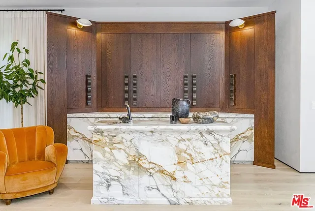 a living room with stainless steel appliances kitchen island granite countertop furniture and a large window