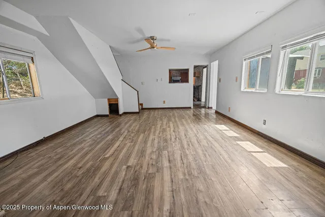 a view of hallway with wooden floor