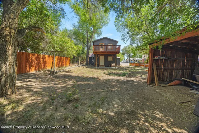 a view of a house with wooden fence