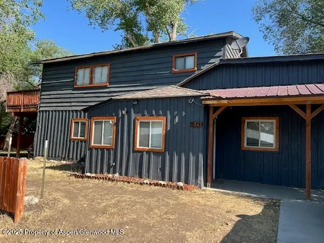 an aerial view of a house with a yard and sitting area