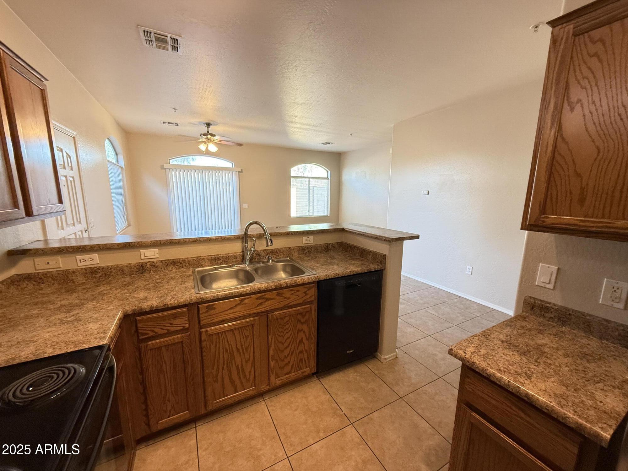 2150 East Bell Road, Unit 1138 Phoenix, AZ 85022 - Photo 11 of 38 a kitchen with a sink and a stove