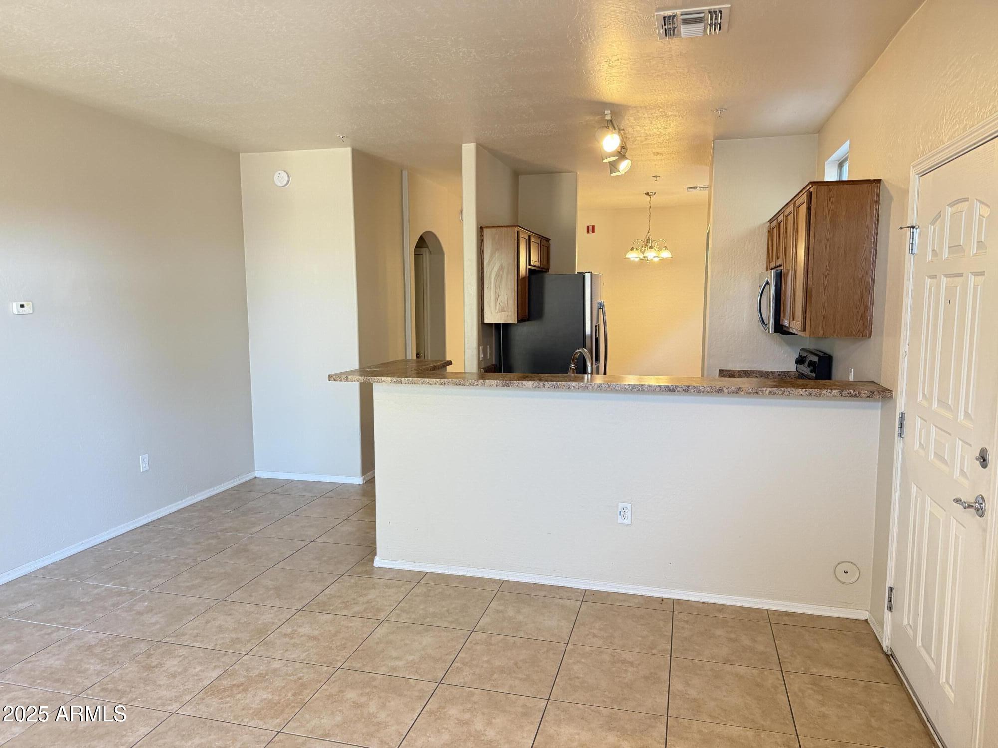 2150 East Bell Road, Unit 1138 Phoenix, AZ 85022 - Photo 17 of 38 a view of a kitchen cabinets and a room