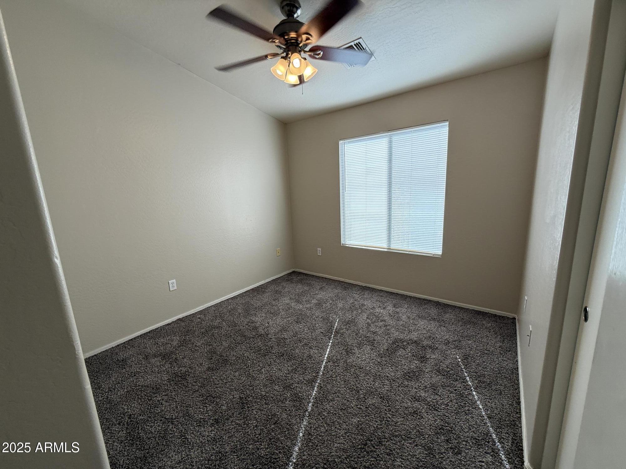 2150 East Bell Road, Unit 1138 Phoenix, AZ 85022 - Photo 21 of 38 an empty room with windows and fan