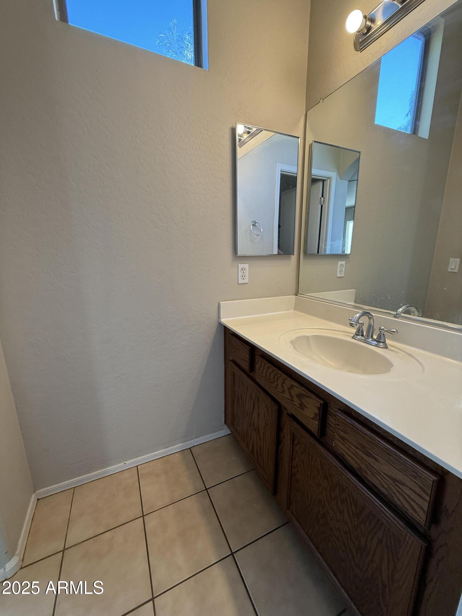 2150 East Bell Road, Unit 1138 Phoenix, AZ 85022 - Photo 23 of 38 a bathroom with a sink and a mirror
