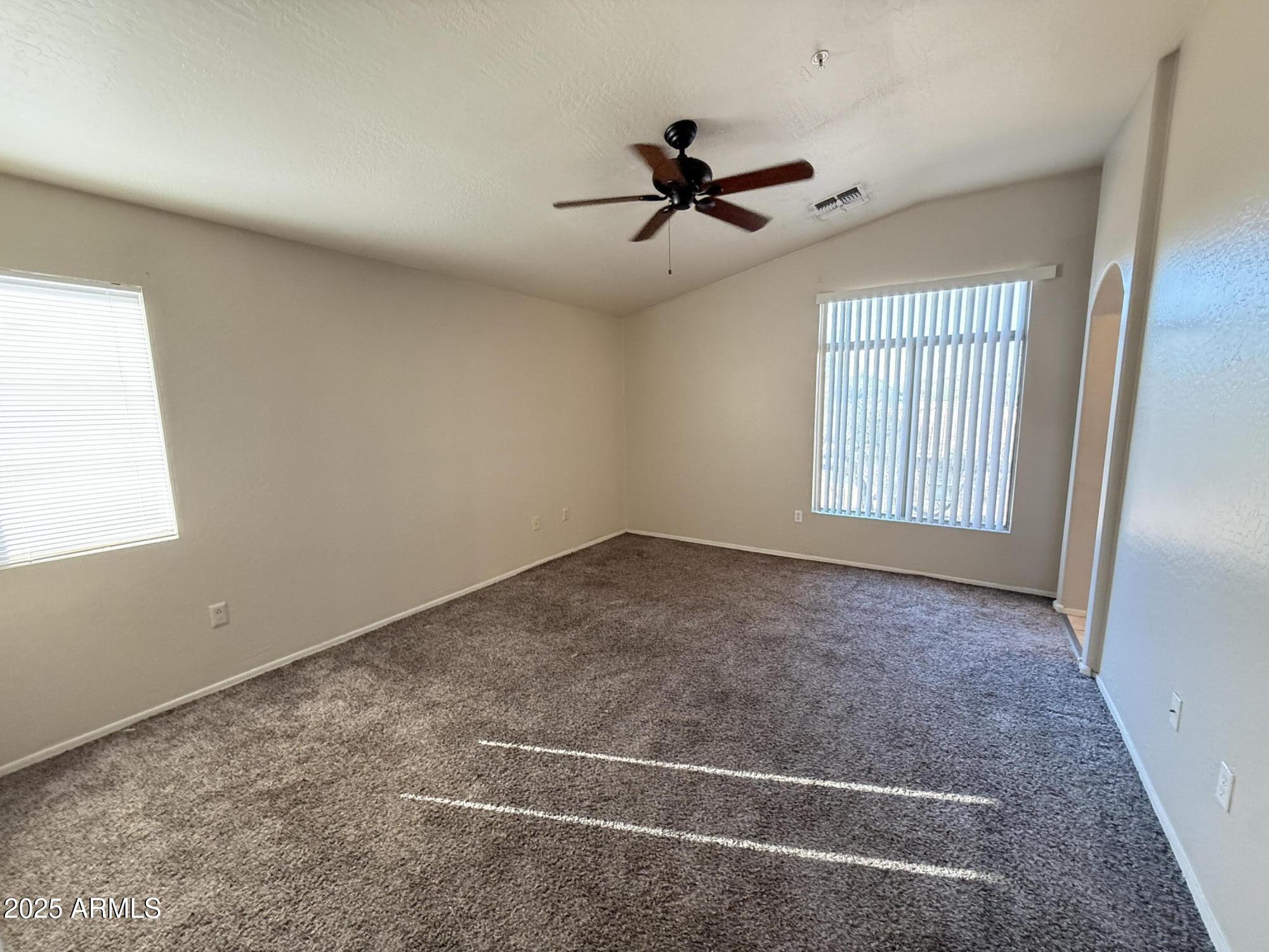 2150 East Bell Road, Unit 1138 Phoenix, AZ 85022 - Photo 25 of 38 an empty room with windows and fan