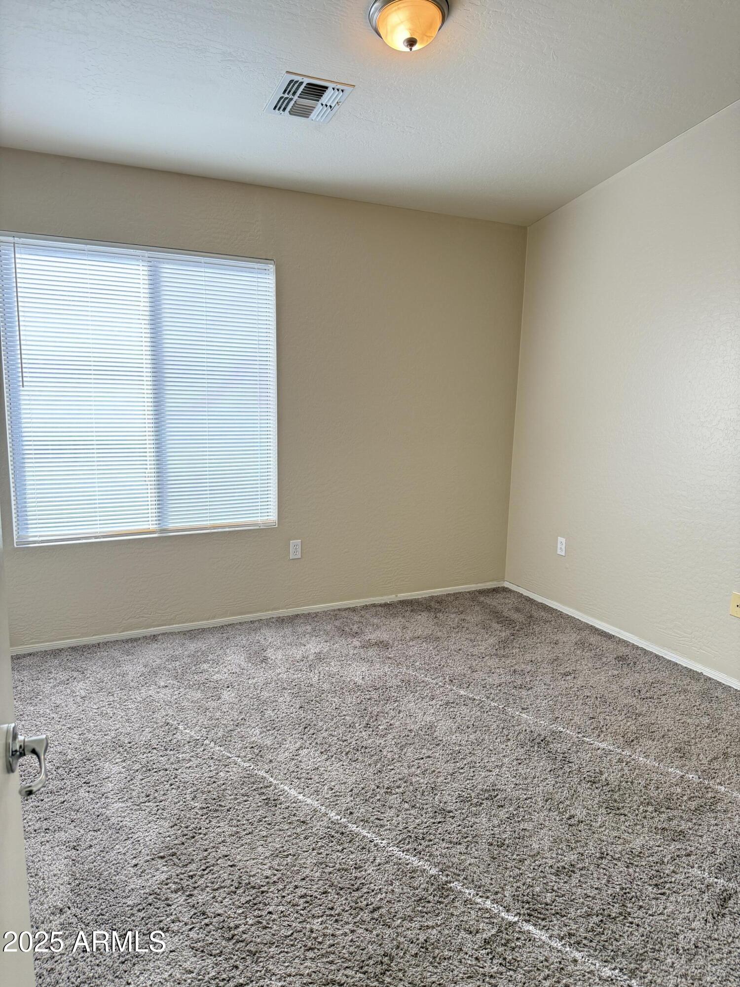 2150 East Bell Road, Unit 1138 Phoenix, AZ 85022 - Photo 26 of 38 an empty room with a window