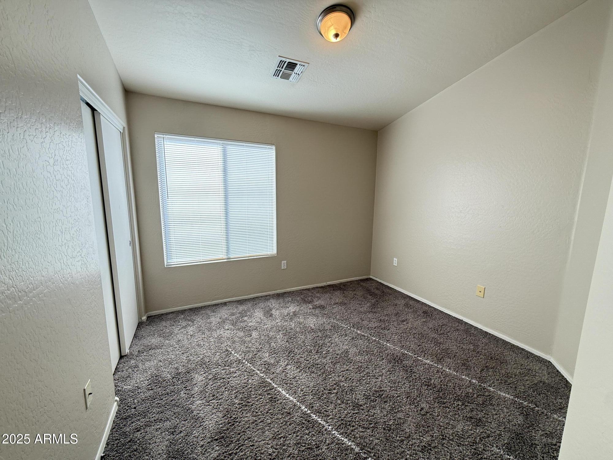 2150 East Bell Road, Unit 1138 Phoenix, AZ 85022 - Photo 27 of 38 an empty room with a window