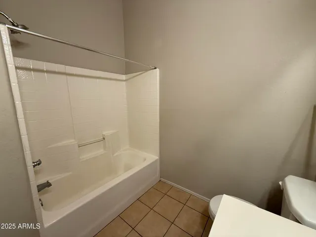 a bathroom with a bathtub and a toilet