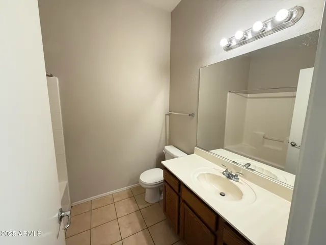 a bathroom with a sink toilet and mirror