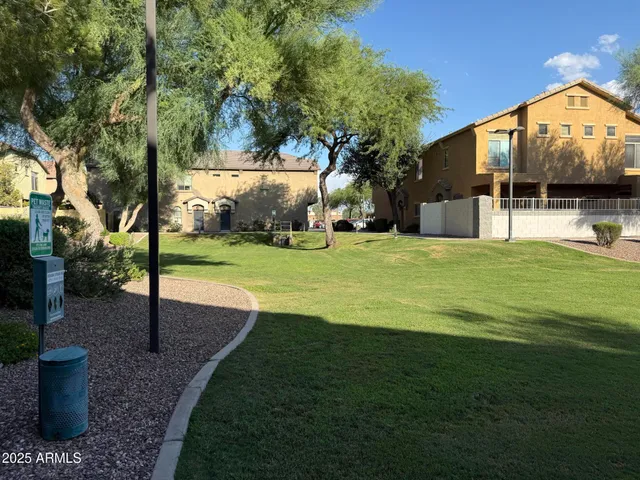 a view of a house with backyard and a tree