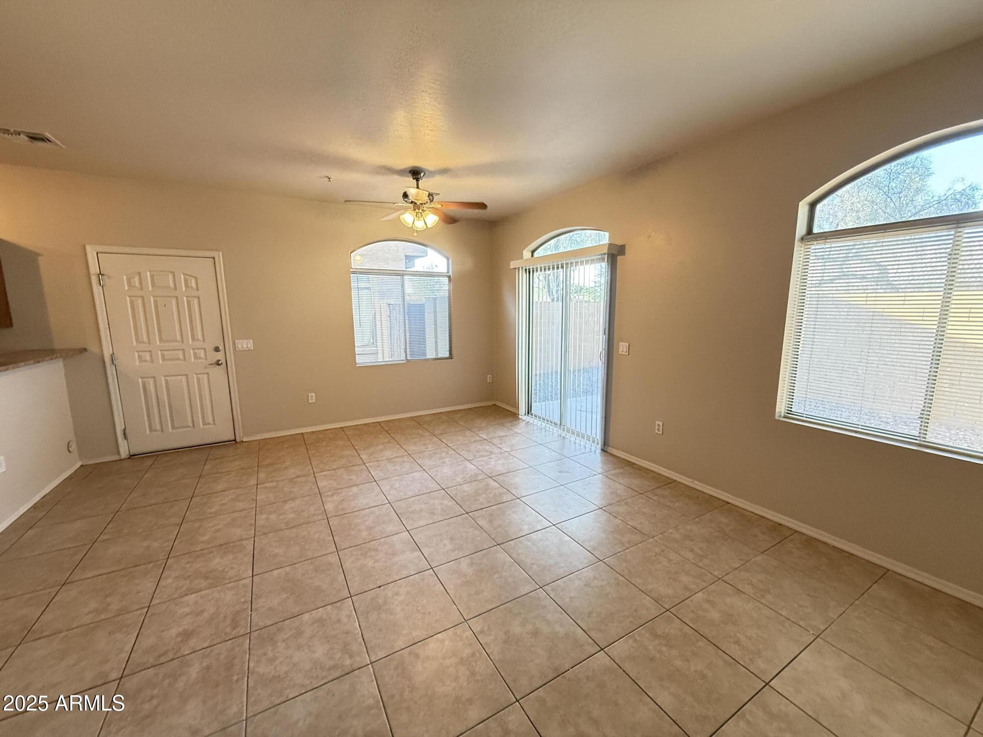 2150 East Bell Road, Unit 1138 Phoenix, AZ 85022 - Photo 7 of 38 a view of an empty room with a window