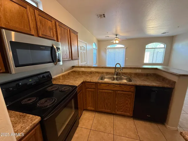 a kitchen with stainless steel appliances granite countertop a sink and a stove