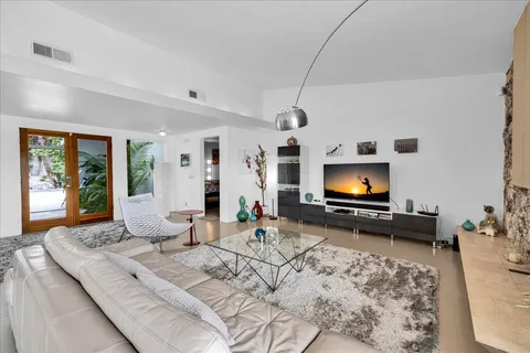a bedroom with furniture and a flat screen tv