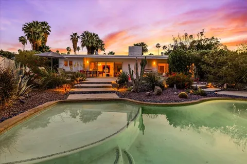 a view of a swimming pool with outdoor seating
