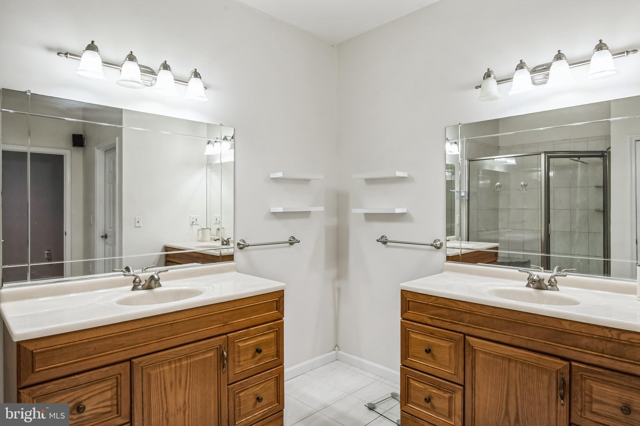 8419 Ingleton Road Easton, MD 21601 - Photo 35 of 58 a bathroom with a sink double vanity and a mirror