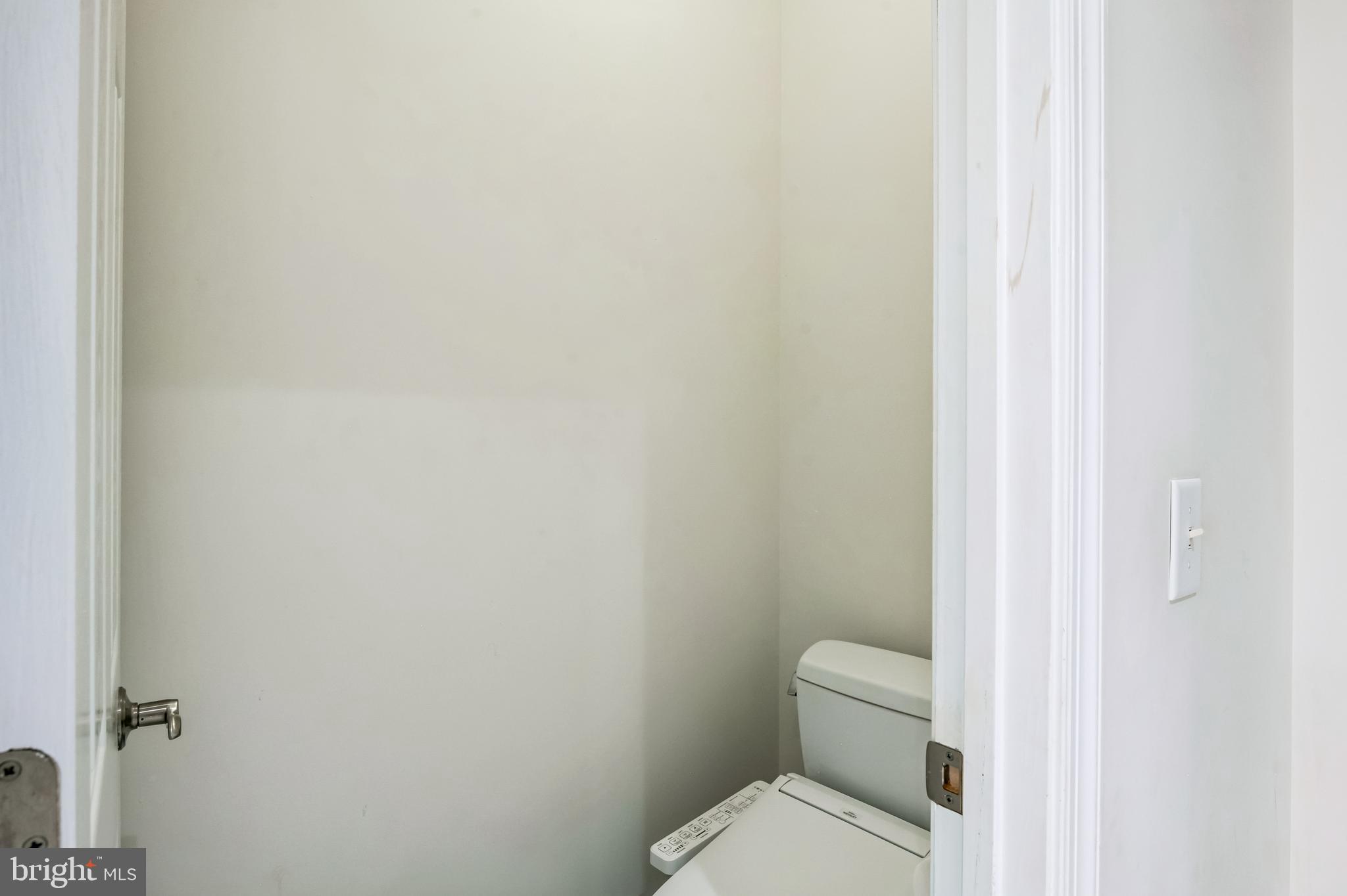 8419 Ingleton Road Easton, MD 21601 - Photo 37 of 58 a white toilet sitting next to a white cabinet