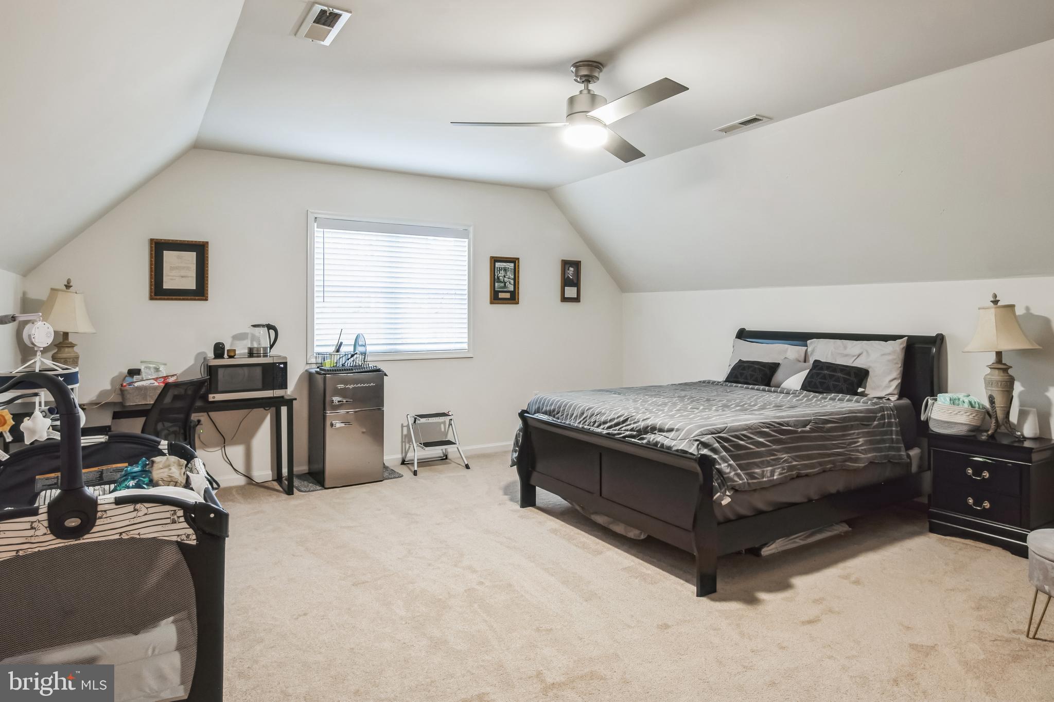 8419 Ingleton Road Easton, MD 21601 - Photo 43 of 58 a bedroom with a bed a table and with chair