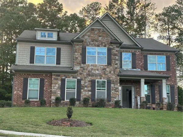 a front view of a house with a yard