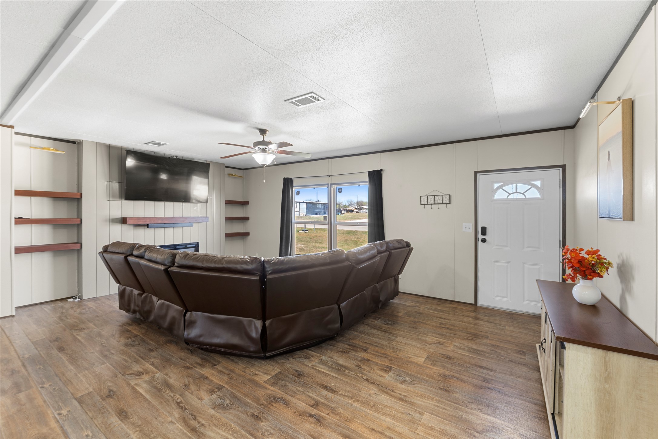 22774 Windy Mdws Cove Jarrell, TX 76537 - Photo 11 of 30 a living room with furniture and a flat screen tv