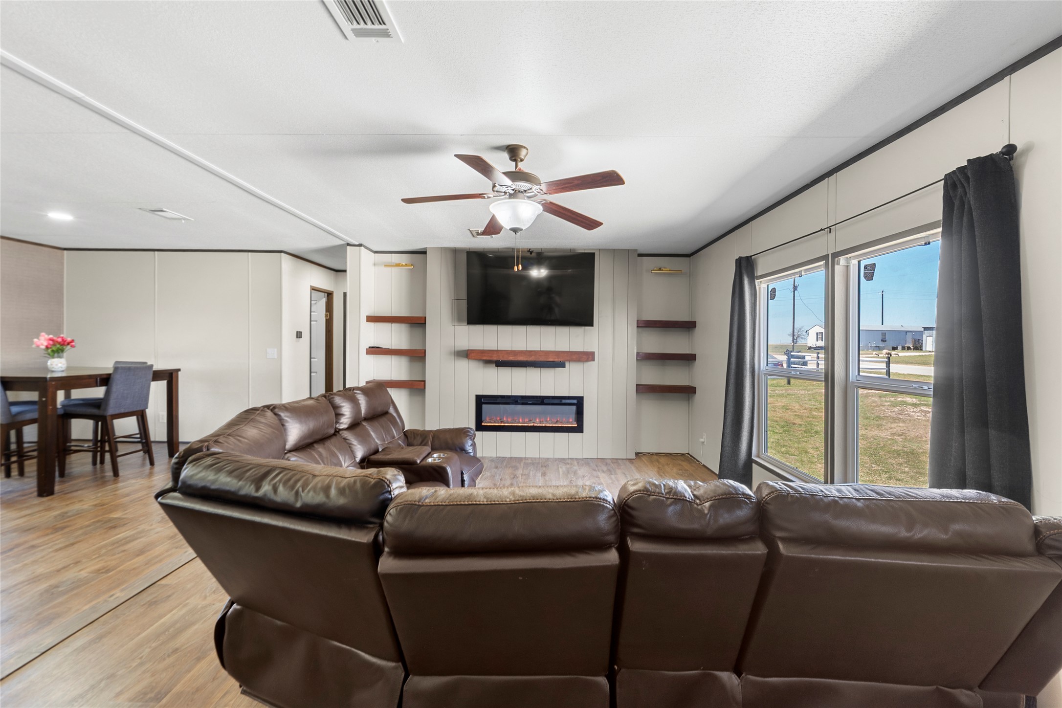 22774 Windy Mdws Cove Jarrell, TX 76537 - Photo 12 of 30 a living room with furniture and a flat screen tv